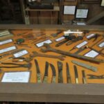 Photo of a display filled with an assortment of knives and tools